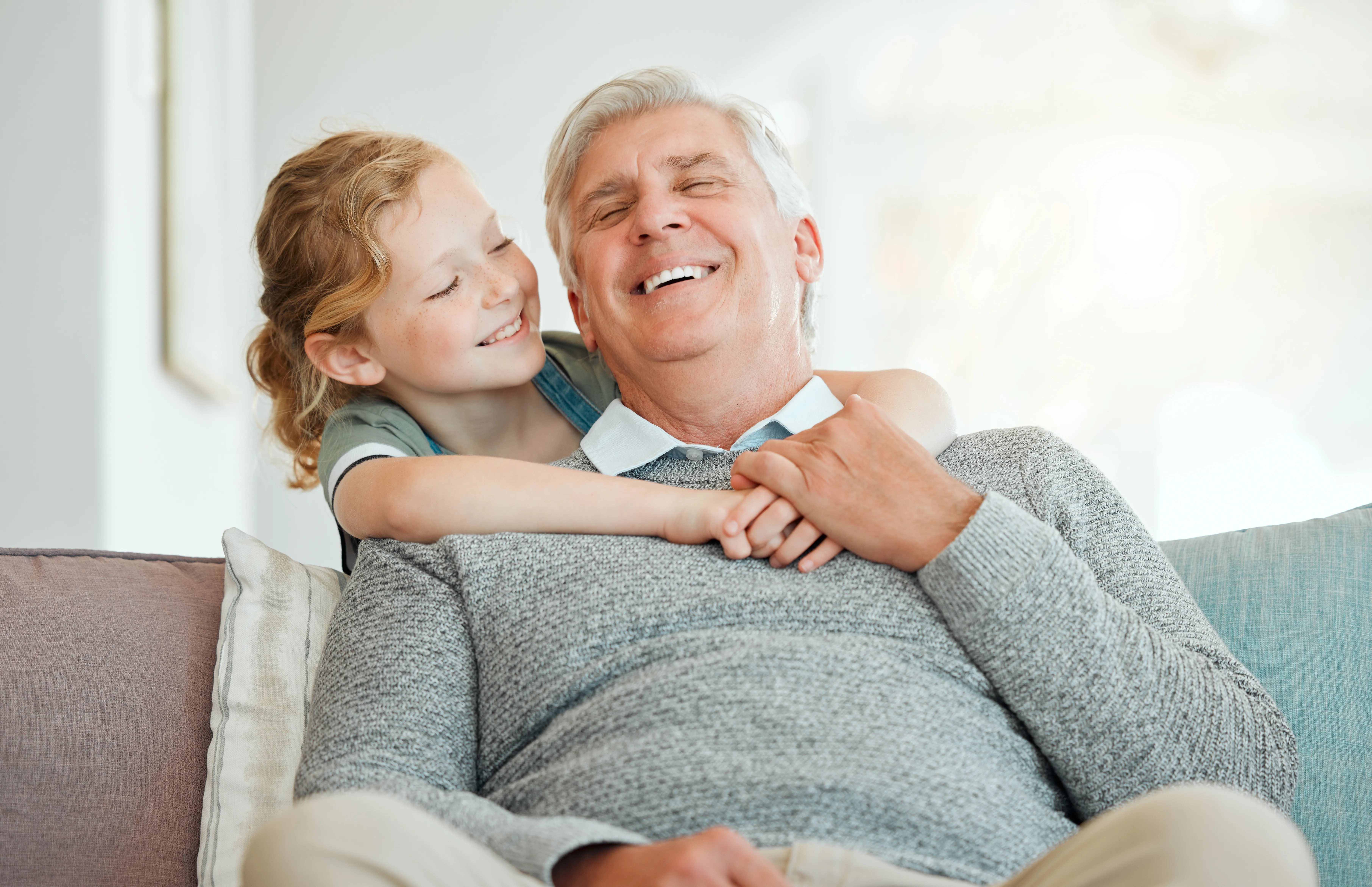 A grandfather smiling with a child
