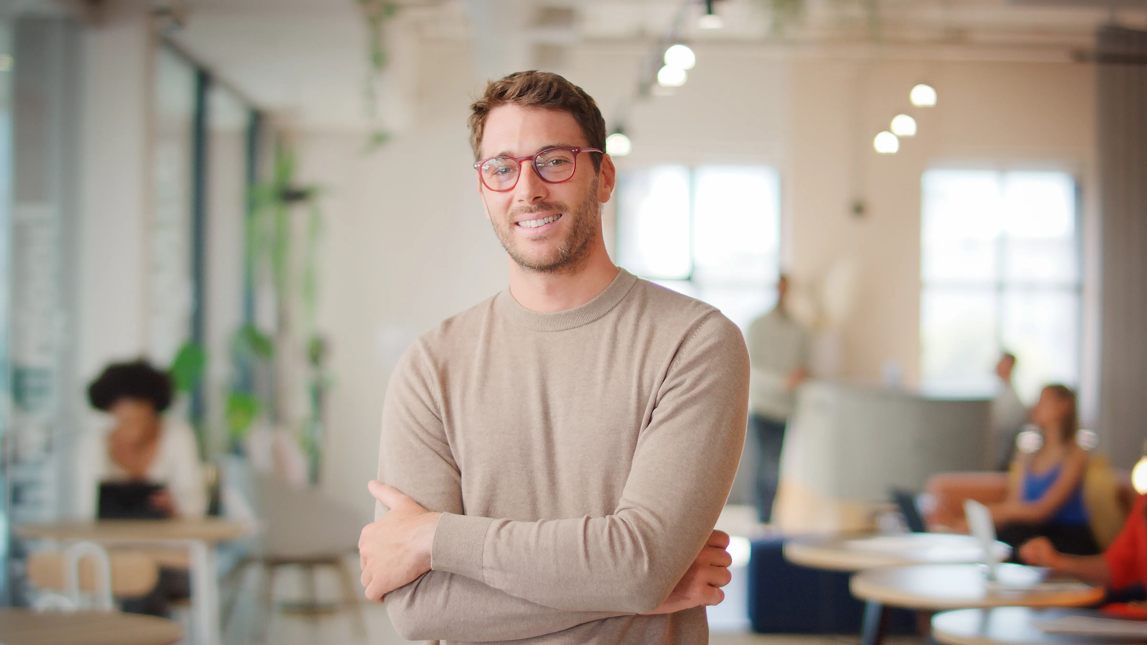 A smiling adult in a modern interior